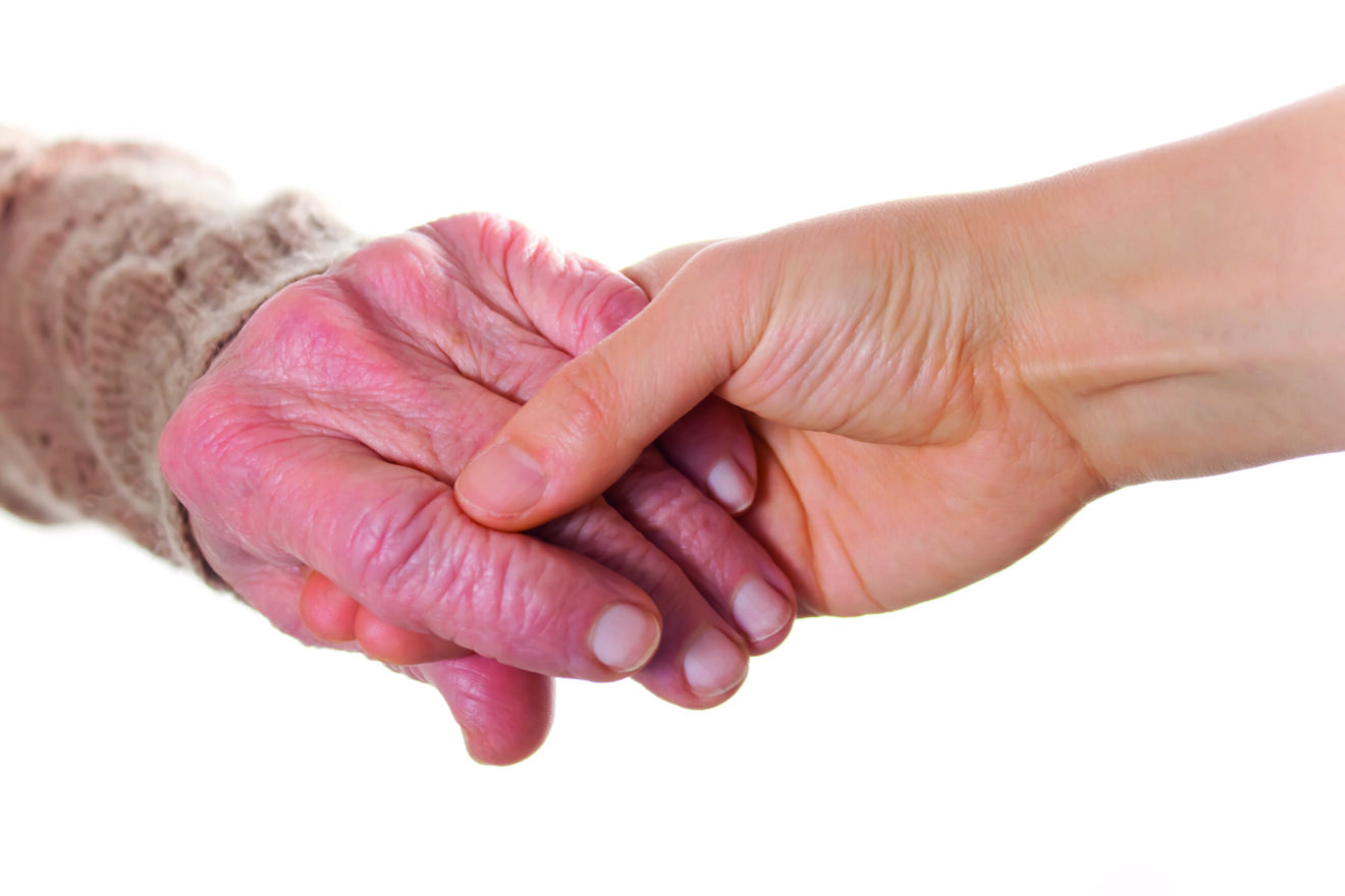 Senior and Young Women Holding Hands