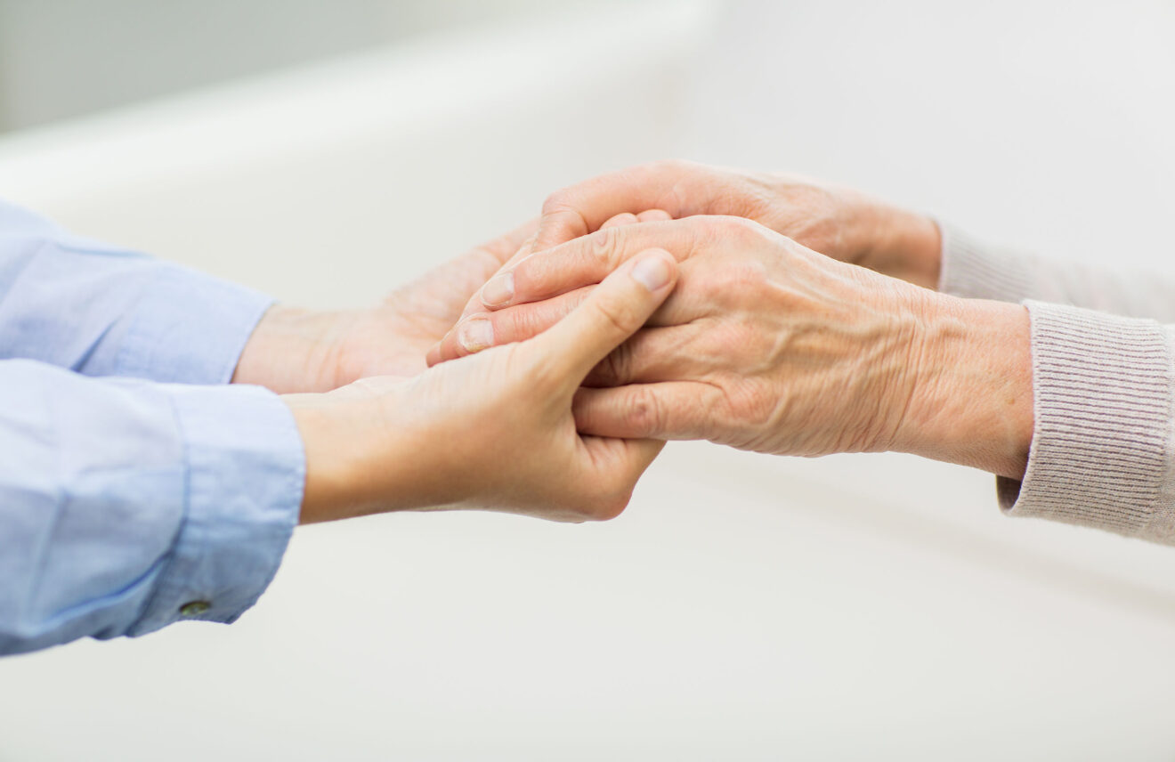 close up of senior and young woman hands